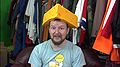 Graham wears a foam Cheesehead hat in Wrong Lot, Right Andy.