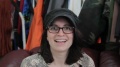For the second time, Kathleen takes a hat from Alex, this time his trademark black ballcap. Seen in Tour de Bad Dates.